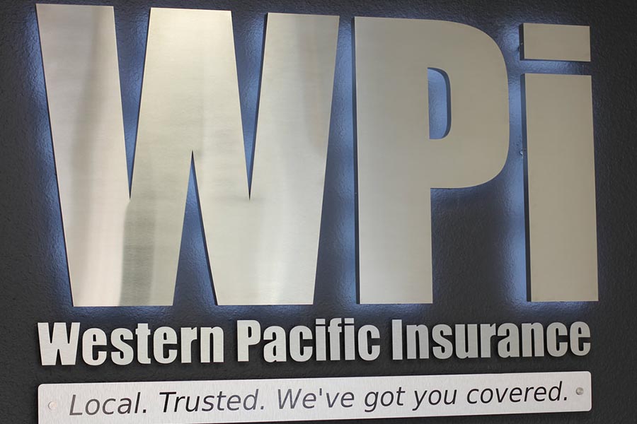 Office Tour - Metallic WPI Company Sign Stating Western Pacific Insurance, Local, Trusted, We've Got You Covered