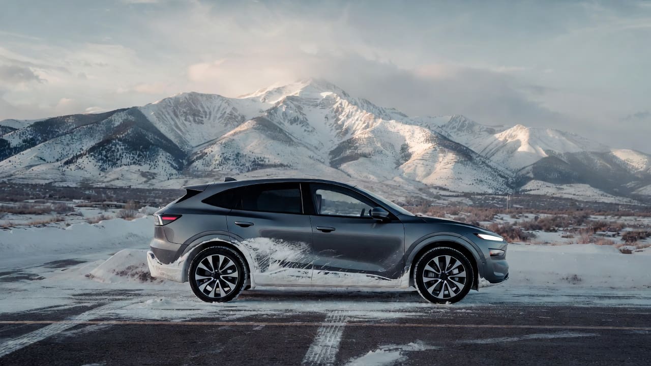 Vehículo híbrido en una carretera nevada de montaña en Utah, lo que representa un riesgo de pérdida total de la batería debido al clima frío y la sal de la carretera.